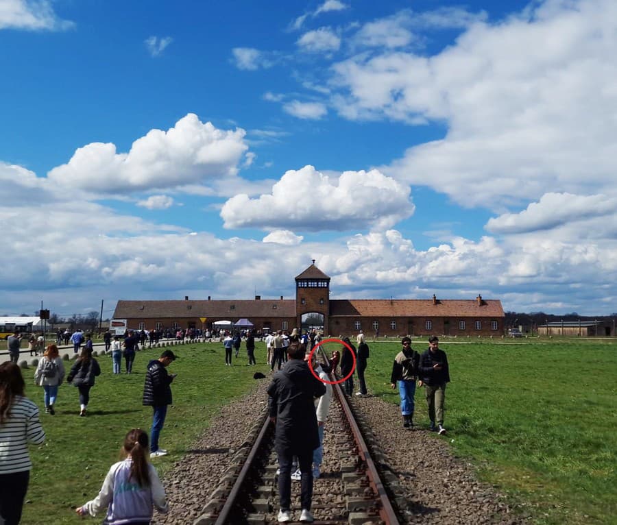 Dievčina sedela vysmiata na koľajniciach,