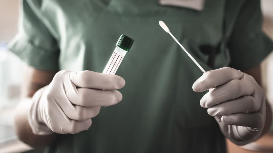 nurse holds a swab