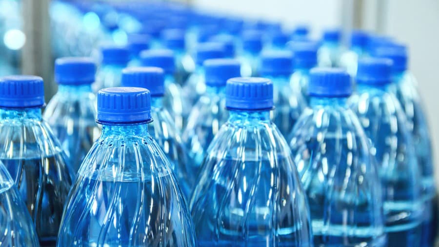 Closeup on mineral water green bottles in raw and lines