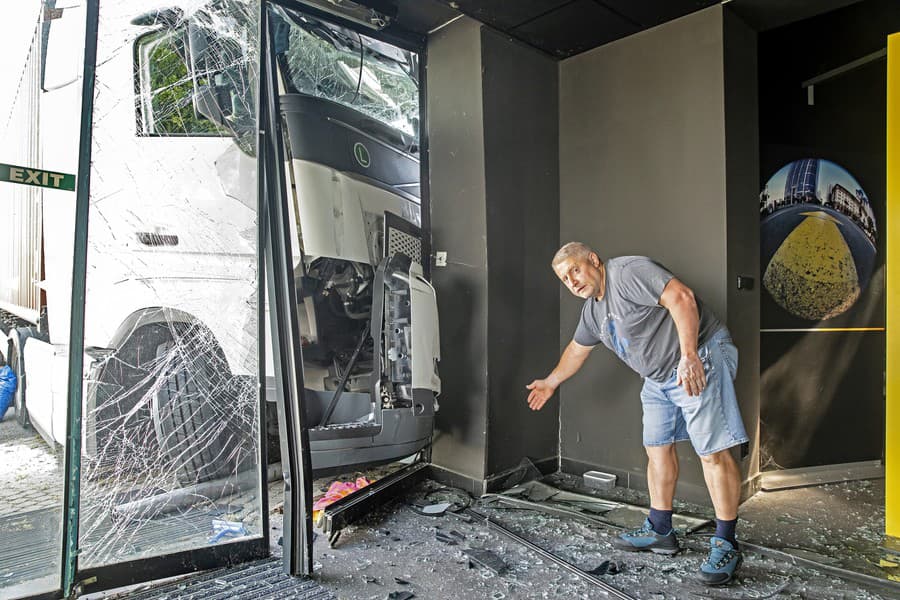 Zástupca majiteľa showroomu Ivan (56) ukazuje rozsah škôd.