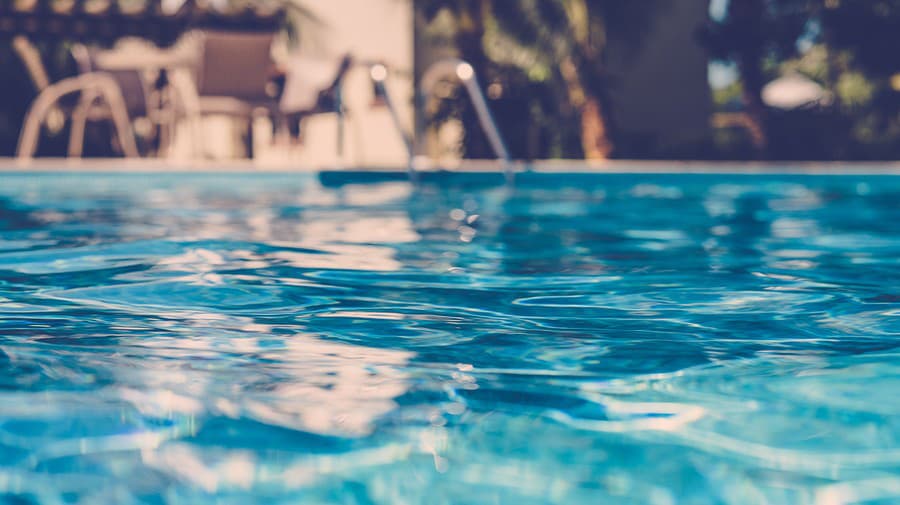 blurred surface view on blue swimming pool