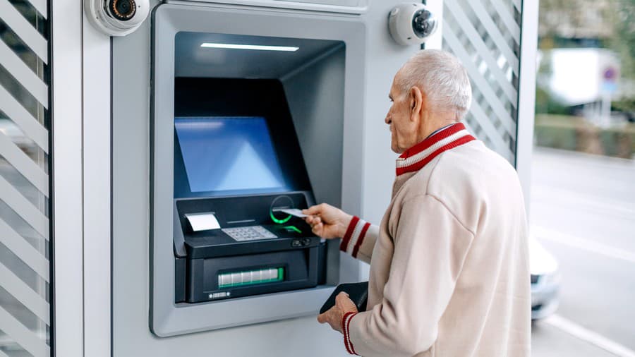 Senior adult using ATM