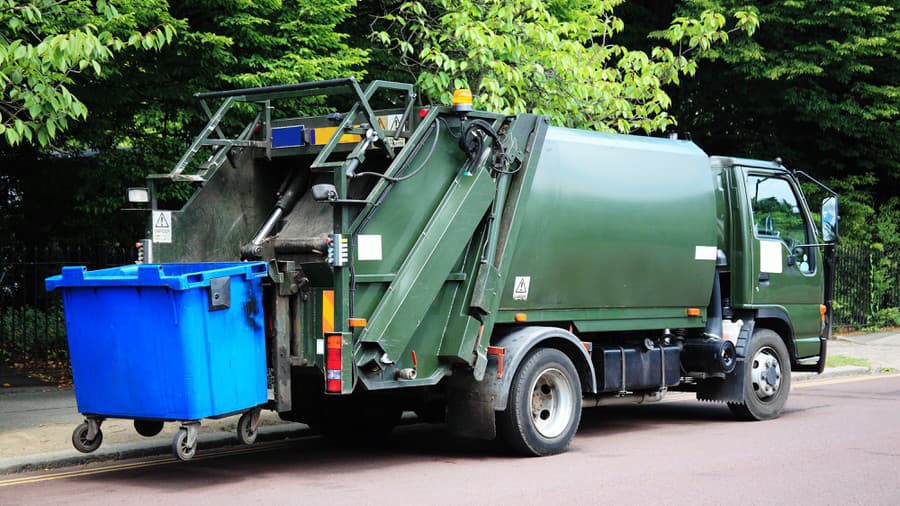 Green garbage truck with