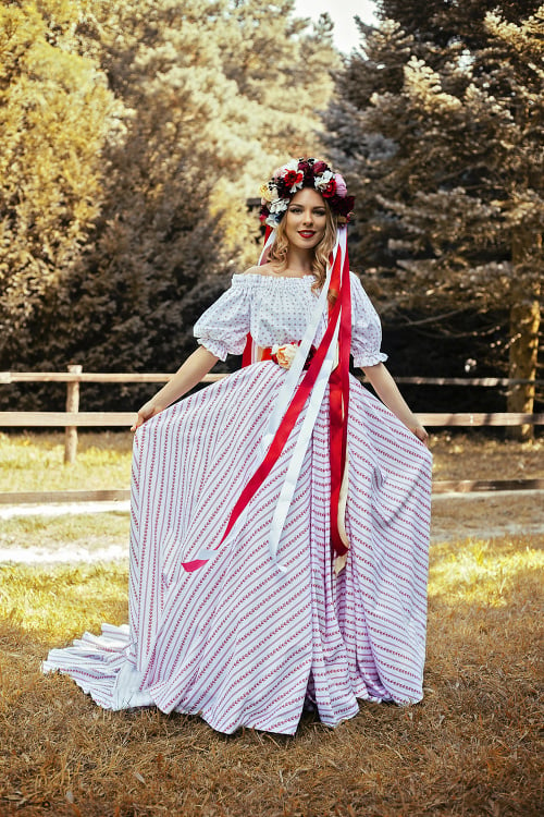 Šaty vytvorila mladá dizajnérka Katarína Vavrová. Sú typicky slovenské s ľudovým motívom a boli ušité priamo pre Veroniku na naše fotenie. 