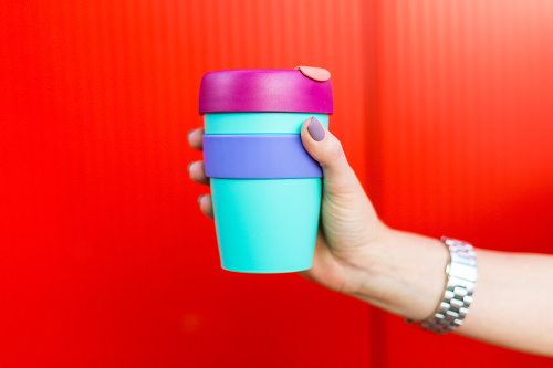 Young woman holding a colorful coffee mug