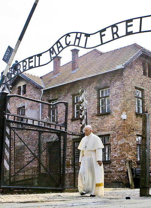 Pápež prechádza cez vstupnú bránu bývalého koncentračného tábora s nápisom Arbeit macht frei - Práca oslobodzuje.