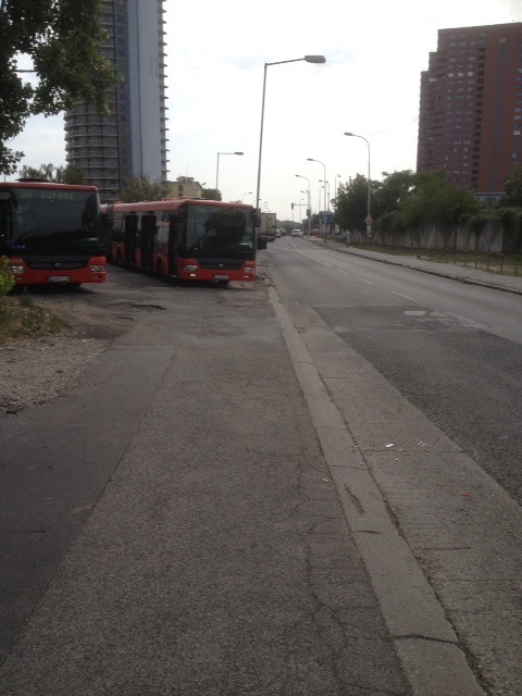 Autobus na konečnej stojí na chodníku.