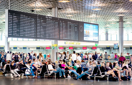 Cestujúci na letisku v Hannoveri čakajú na svoje omeškané lety.