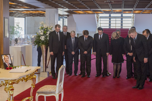 Expremiér SR a predseda SMER-SD Robert Fico (vpravo) a členovia strany SMER-SD sa ukláňajú pred kondolenčnou knihou.