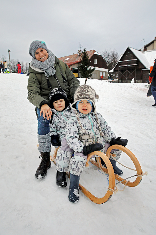 Adam (4), Šimon (3) a Lenka (39) z Bratislavy sa vyšantili v snehu na sánkach.