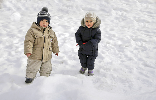 Banská Bystrica - Matej (1,5 roka) a Miško (1,5 roka) z Banskej Bystrice sa hrajú na snehu pred bytovkou a vôbec im neprekáža, že sú vonku - 4 °C.