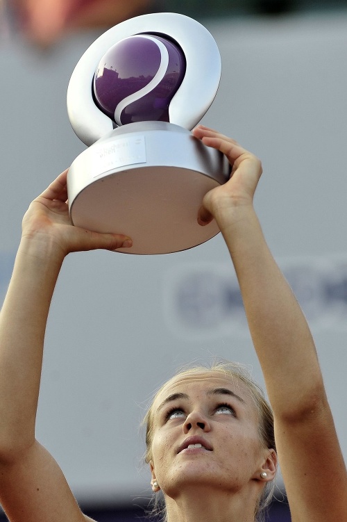 Slovenská tenistka Anna Karolína Schmiedlová drží nad hlavou trofej po zisku druhého titulu na okruhu WTA po triumfe na antukovom turnaji v Bukurešti. 