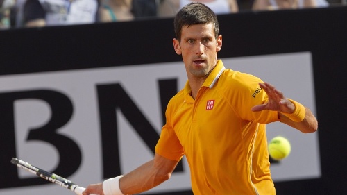 Srbský tenista Novak Djokovič odvracia loptičku Švajčiarovi Rogerovi Federerovi.