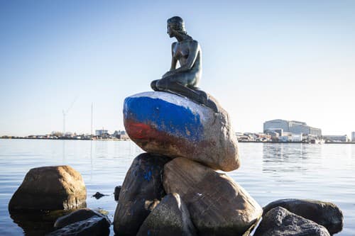 Ruskú vlajku namaľoval niekto na prednú stranu skaly, na ktorej je umiestnený symbol dánskej metropoly Kodaň — socha Malej morskej víly