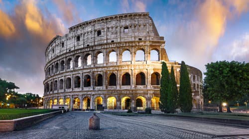 Colosseum in Rome at sunset with lights, Italy