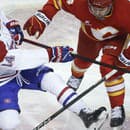 Nick Suzuki z Montreal Canadiens (vľavo) je atakovaný Rasmusom Anderssonom z Calgary Flames.







