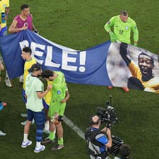 Brazílski futbalisti pózujú s transparentom Pelého.