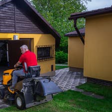 Vůjtek má svoj záhradný traktor zaparkovaný v garáži.