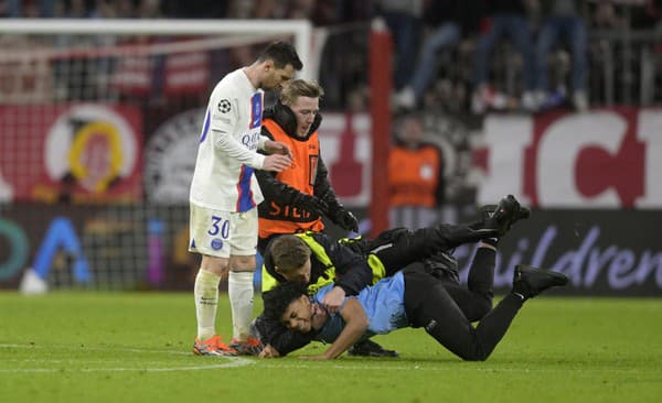 Usporiadatelia museli ochrániť Lionela Messiho pred fanúšikom, ktorý vybehol na trávnik.