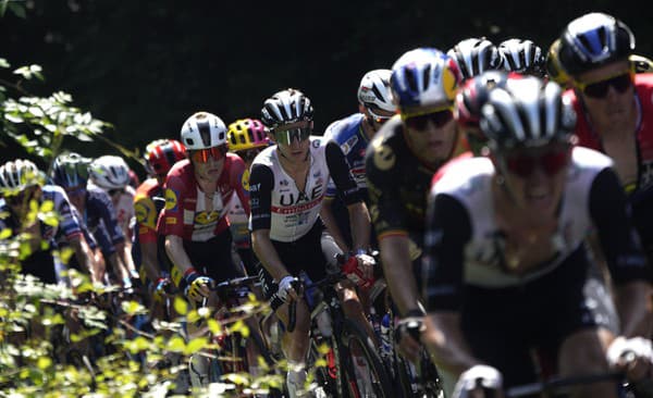 Skupina cyklistov šliape do pedálov počas prvej etapy cyklistických pretekov Tour de France.