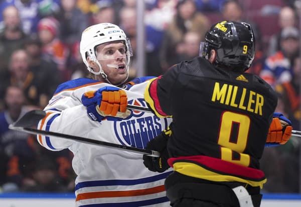 Connor McDavid (vľavo) bol v zápase s Vancouverom neustále atakovaný hráčmi súpera.