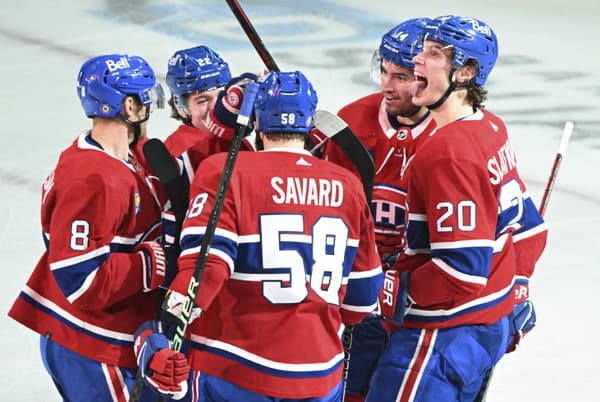 Slovenský hokejista Juraj Slafkovský (20) z Montrealu Canadiens sa raduje z gólu so spoluhráčmi.